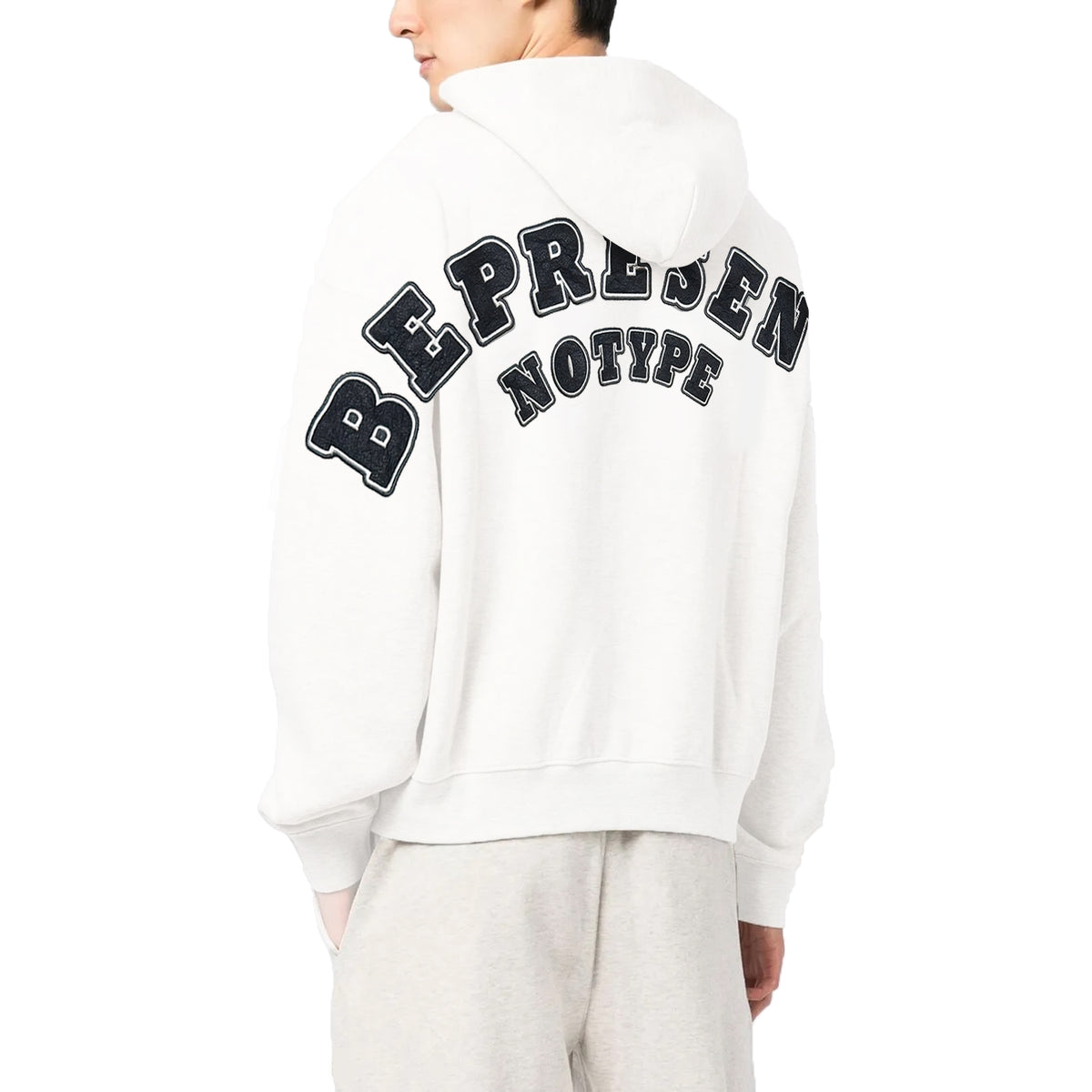 NoType BE PRESENT zip-up hoodie in white worn by a model, back view